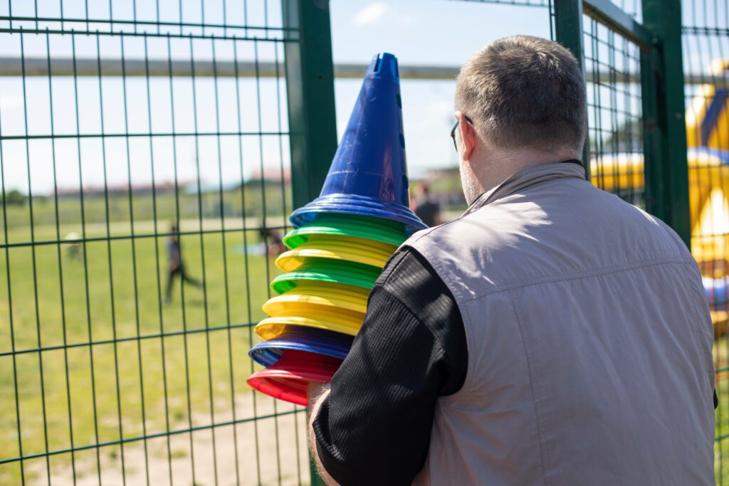 Central Sport volunteer brining cones into a soccer pitch.